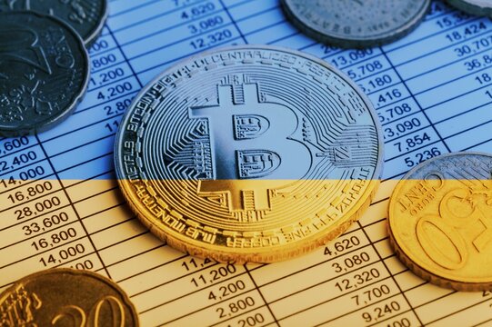 Physical version of Bitcoin and the color Ukrainian flag. Conceptual of Ukraine's cryptocurrency and blockchain technology.