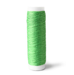 Green sewing thread spool on light background