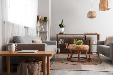 Interior of room with shelf units, sofa and table