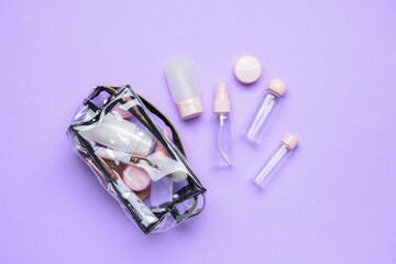 Empty travel bottles and bag with cosmetics on lilac background