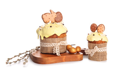 Delicious Easter cakes decorated with cookies on white background