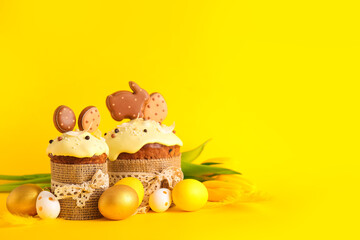 Delicious Easter cakes decorated with cookies, flowers and painted eggs on background