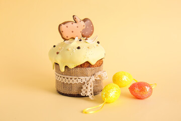 Delicious Easter cake decorated with cookies and eggs on beige background