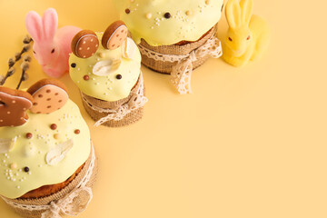Delicious Easter cakes decorated with cookies on beige background