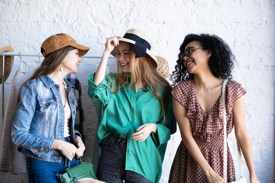 Happy women at swap party. Choose casual clothes, shoes, hats, bags, jewellery. Idea of exchange your old wardrobe for new. Eco friendly cloth concept. Zero waste shopping, reduce and reuse, donation