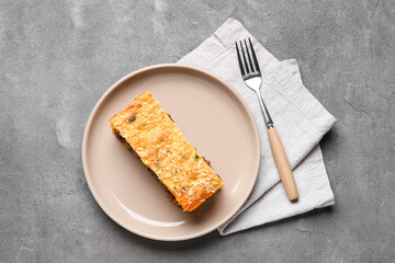 Plate with piece of tasty Shepherd's pie on grey background