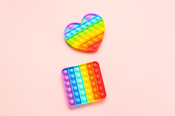 Pop it fidget toys on pink background. Concept of autistic disorder