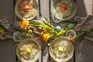 Beautiful table setting with painted Easter eggs and floral decor