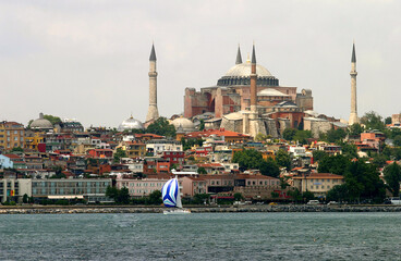 Obraz premium Sailing boat at Bosphorus with Hagia Sofia in Istanbul, Turkey. 