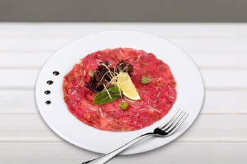 Sliced meat beef collection roasted and raw with herbs.