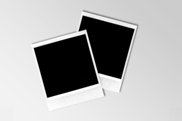 Two old vintage photo borders with tape on desk, blank frames.