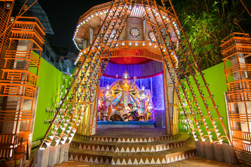 KOLKATA , INDIA - OCTOBER 18, 2015 : Night image of decorated Durga Puja pandal, shot at colored...