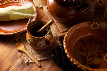 Authentic homemade mexican coffee (cafe de olla) served in traditional clay mug (Jarrito de barro)...