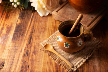 Authentic homemade mexican coffee (cafe de olla) served in traditional clay mug (Jarrito de barro)...