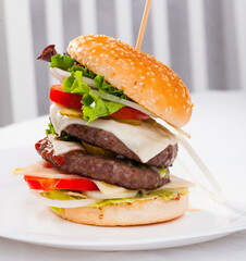 Appetizing double cheeseburger with two grilled beef patties.