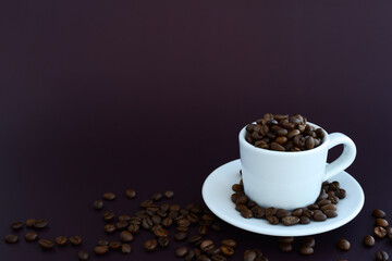 Coffee beans in coffee cup on a brown background, copy space