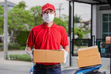 Deliveryman of goods and parcels to customers by protecting them with medical masks and gloves , Online shopping order under quarantine coronavirus covid-19