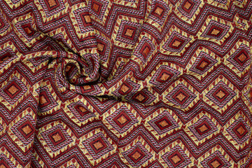 Red Thai cloth with diamond pattern,crumpled nativeThai style It is popularly worn by women in Thai traditions.
 background.