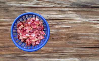 Shallots on plastic bowl for drying in the sun at a farmer's house in Thailand to preserve food for longer, natural herbs Shallots are garden spices. healthy vegetables.