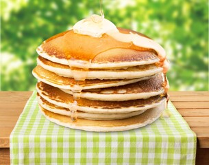 Stack of traditional Russian pancakes on wooden desk. Traditional Russian food.