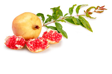 Fresh juicy pomegranate in whole and cut with green leaves isolated on white background. Clipping path.