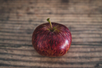 home-grown red apple on wooden background