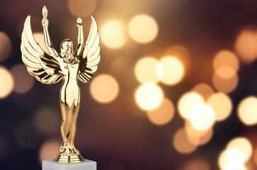 Hollywood Golden Academy award statue on fireworks background. Success and victory concept.