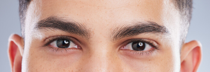 I see you too. Shot of an handsome young mans eyes against a studio background.