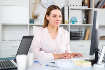 Businesswoman is working with documents and computer in the office