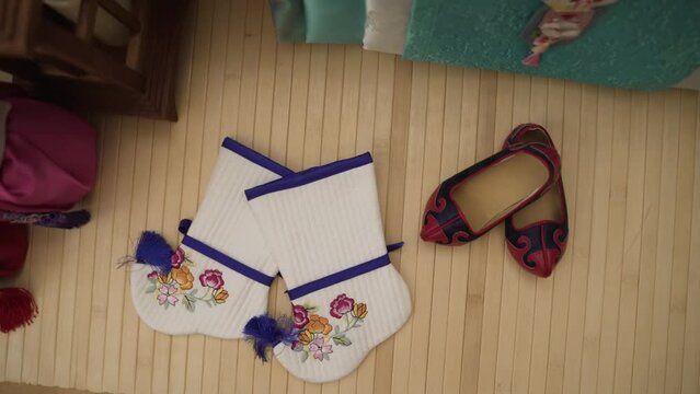 Festive children's white socks and slippers lie on the floor.