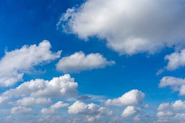 Beautiful blue sky with white cumulus clouds floating