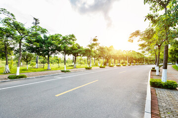 Fototapeta na wymiar Empty asphalt road with trees on both side