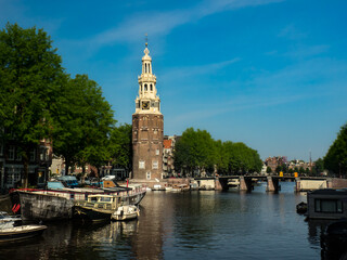 Fototapeta premium View from the Kikkerbilssluis bridge to the canal in Amsterdam 