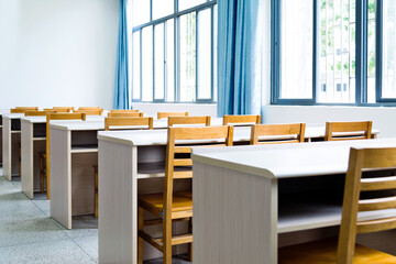 Empty classroom with chairs, desks and chalkboard