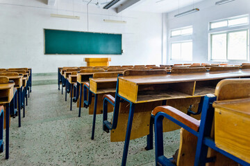 Empty classroom with chairs, desks and chalkboard