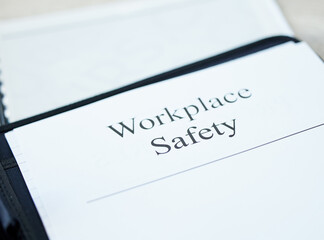 Obraz premium Know the rules, they could save your life. Shot of a document with Workplace Safety on it in an office.