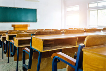 Empty classroom with chairs, desks and chalkboard