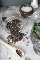 Spice black pepper. Black peppercorns in a glass jar. Food ingredient, flavor additive