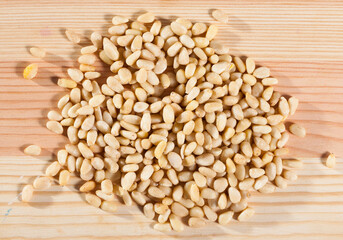 Photo of mix pine nut on the wooden desk, nobody..