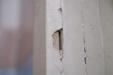 Selective focus, broken, old, ruined wall, cracked plaster in an abandoned apartment close-up.