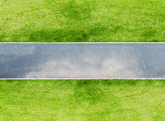 Overlooking an asphalt road across the green lawn