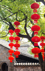 Strings of red lanterns hanging in the park during Chinese New Year
