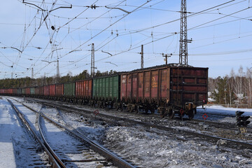 Fototapeta na wymiar Freight wagons with coal at the railway station. Loading wagons for export.