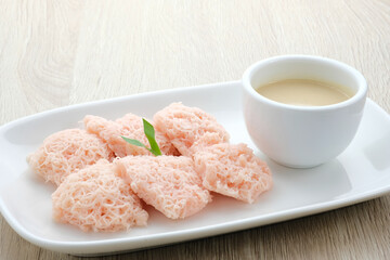 Kue Putu Mayang is traditional Indonesian snack made from rice flour strands curled up into a ball, served with coconut milk and palm sugar. Selected focus.
