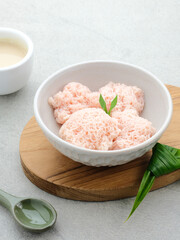 Kue Putu Mayang is traditional Indonesian snack made from rice flour strands curled up into a ball, served with coconut milk and palm sugar. Selected focus.
