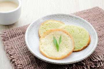 Serabi or Surabi,  Indonesian pancake made of flour, rice flour and coconut milk. Served with palm sugar sauce. Sweet and savory. 
