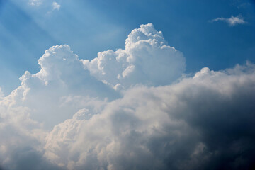 Naklejka na ściany i meble Bright sunlight in blue sky with clouds