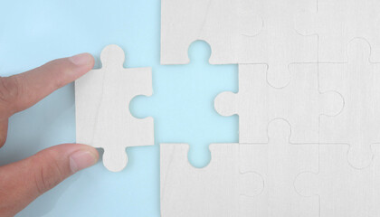 Connecting jigsaw puzzle in hand. Business solutions success and strategy concept