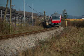 Older type diesel railcar is driving through the fields in the spring. Slovenian diesel multiple...