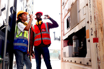 Two industrial African American worker engineer man and woman wearing safety vest and helmet, drinking water from bottle during take a break after work hard at logistic shipping cargo container yard. - Powered by Adobe